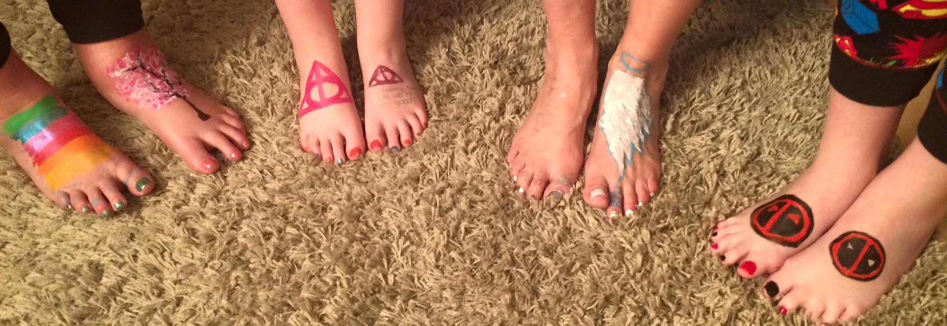 Children's feet painted with symbols